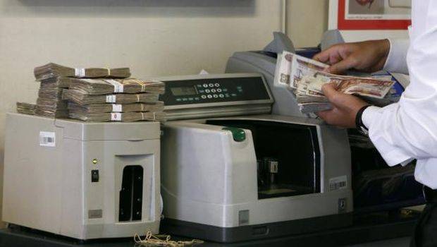 File photo of an employee counting money in a bank in Cairo. (REUTERS)