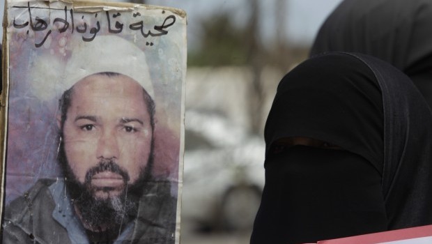 A Salafist protester wearing a niqab gestures next to a sign during a protest in Rabat May 16, 2013. Source: Reuters/Stringer