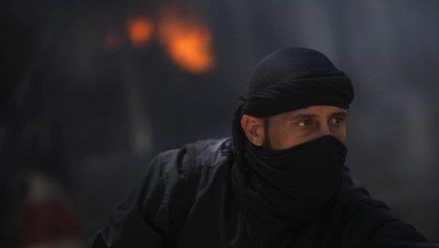 File photo shows a fighter from Jabhat al-Nusra in front of a burning vehicle at their base in Raqqa. (REUTERS/Hamid Khatib/File)
