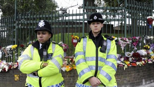Two police officers stand at the scene where Drummer Lee Rigby, of the 2nd Battalion The Royal Regiment of Fusiliers, was murdered in John Wilson Street, Woolwich, South London, Britain, 24 May 2013. (EPA/FACUNDO ARRIZABALAGA)