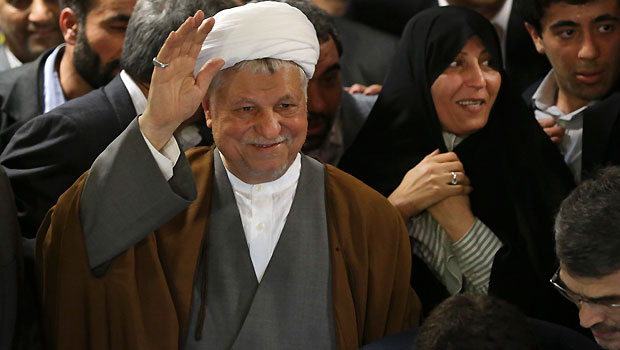 n this Saturday, May 11, 2013 photo, former President Akbar Hashemi Rafsanjani, waves to media, as he registers his candidacy for the upcoming presidential election, while his daughter Fatemeh, smiles at second right, at the election headquarters of the interior ministry in Tehran, Iran.  (AP Photo/Ebrahim Noroozi)