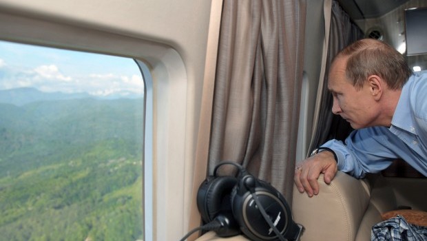 Russian President Vladimir Putin looks out the window as he and Britain's prime minister fly by helicopter to inspect the 2014 Winter Olympic facilities after their meeting at the Bocharov Ruchei state residence in Sochi on May 10, 2013. Source: AFP Photo