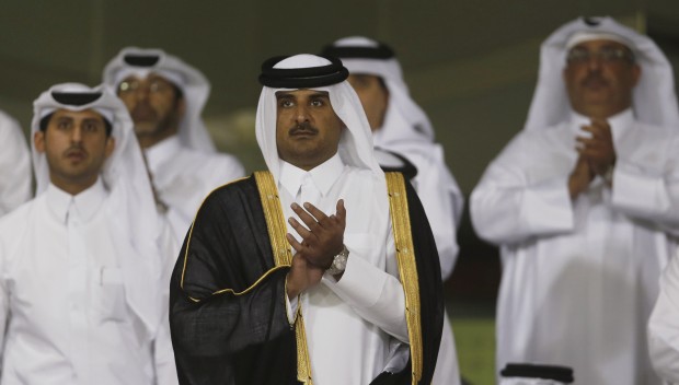 Qatar's Crown Prince Sheikh Tamim bin Hamad al-Thani (C) arrives at Al-Sadd Stadium for the final Crown Prince Cup soccer match between Qatari teams Al-Sadd and Lekhwaiya in Doha May 4, 2013.  (Reuters/Fadi Al-Assaad)