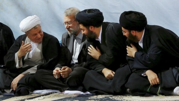 The late Ayatollah Khomeini's grandsons, Ali Khomeini, right, and Yasser Khomeini, second right, greet former President Akbar Hashemi Rafsanjani, left, as parliament speaker Ali Larijani, second left, sits with them during a ceremony commemorating the anniversary of the death of the late revolutionary founder Ayatollah Khomeini at his shrine just outside Tehran, Iran, Tuesday, June 4, 2013 (AP Photo/Office of the Supreme Leader)