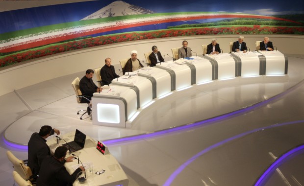 In this photo released by the Islamic Republic of Iran Broadcasting on Wednesday, June 5, 2013, presidential candidates from right, Mohammad Gharazi, Mohammad Reza Aref, Saeed Jalili, Ali Akbar Velayati, Gholam Ali Haddad Adel, Hasan Rowhani, Mohammad Bagher Qalibaf, and Mohsen Rezaei, attend a TV debate in a state-run TV studio, in Tehran.  (AP Photo/Islamic Republic of Iran Broadcasting, Mehdi Dehghan) 