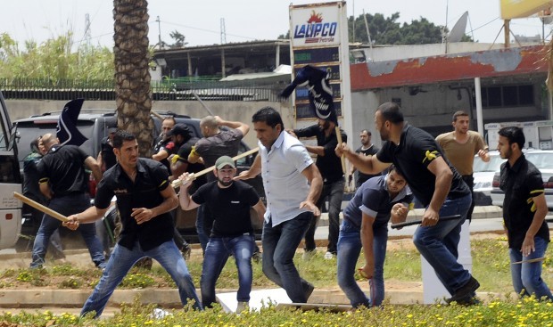 Hezbollah supporters clash with supporters of the Lebanese Option Party during a protest in front of the Iranian Embassy in Beirut, Lebanon, Sunday, June 9, 2013. (AP Photo)