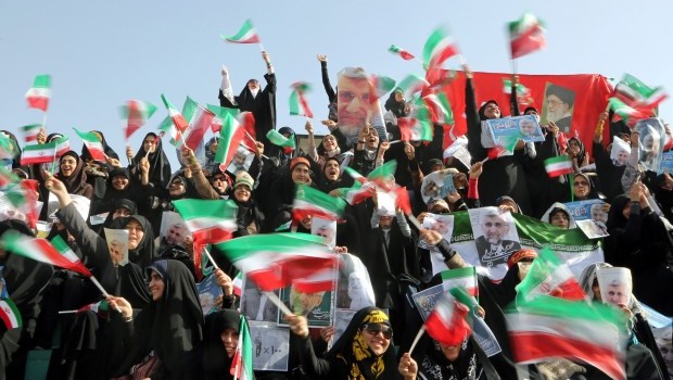 Female supporters of Iranian presidential candidate Saeed Jalili hold posters depicting Jalili and wave Iranian flags during an election campaign rally in Tehran, Iran, 12 June 2013 (EPA/ABEDIN TAHERKENAREH)