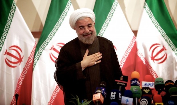 Iranian president-elect Hassan Rowhani salutes to the journalists after his press conference in Tehran on June 17, 2013. (AFP/Behrouz Mehri)