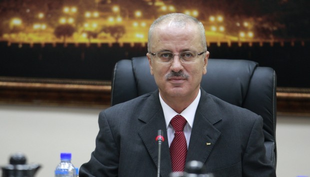 In this Tuesday, June 11, 2013 file photo, New Palestinian Prime Minister Rami Hamdallah attends his first meeting of the new government cabinet in the West Bank city of Ramallah. (AP Photo/Majdi Mohammed, File)