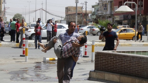 A man wounded by a suicide bomber in Tuz Khurmato city is carried to a hospital in Kirkuk, 250 km (155 miles) north of Baghdad, June 25, 2013.  REUTERS/Stringer (IRAQ - Tags: CIVIL UNREST)