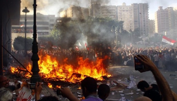 Opponents of Egyptian President Mohamed Morsi burn the content of a Freedom and Justice Party office in the coastal city of Alexandria on June 28, 2013. (AFP)