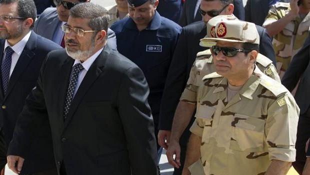 A file photo dated 22 May 2013 shows Egyptian President Mohamed Morsi (L) and Egyptian Minister of Defense Abdel-Fattah al-Sissi (R) arriving to meet seven Egyptian security personnel, who were released by unknown kidnappers in the Sinai Peninsula, at Al-Maza military airport in Cairo, Egypt. EPA/KHALED ELFIQI