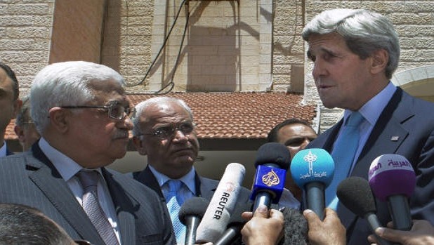 US Secretary of State John Kerry speaks to the press with Palestinian president Mahmoud Abbas following their meeting at the Palestinian presidential compound in the West Bank city of Ramallah on June 30, 2013. AFP PHOTO/JACQUELYN MARTIN