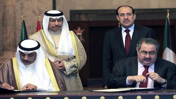 Iraqi and Kuwaiti prime ministers watching foreign ministers, Zebari and Al-Sabah sign agreements in Baghdad, Iraq, Wednesday, June 12, 2013.(AP Photo/ Karim Kadim, Pool)