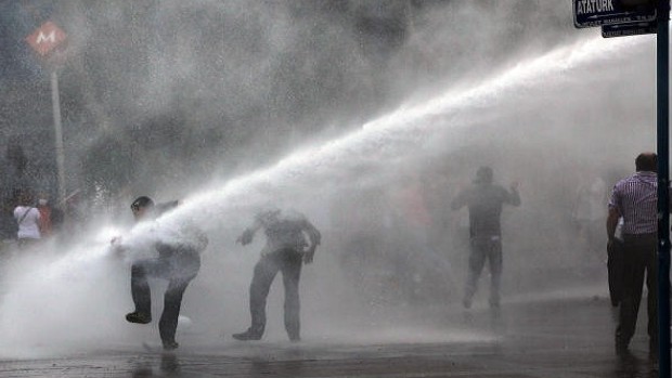 Turkish riot police spray a water cannon at demonstrators, making clear they are taking a hard-line approach against attempts to rekindle protests. Ankara, Turkey, Sunday, June 16, 2013. (AP Photo/Burhan Ozbilici)