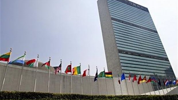  FILE - In this Sept. 13, 2005 file photo, the flags of member nations fly outside the General Assembly building at the United Nations headquarters in New York. (AP Photo/Adam Rountree, File) 