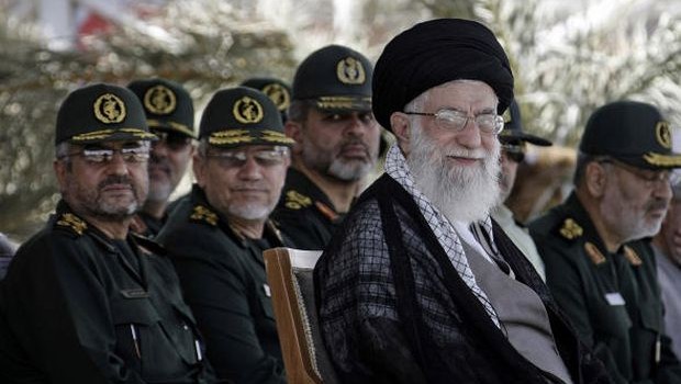 In this photo released by the official website of the Iranian supreme leader's office, supreme leader Ayatollah Ali Khamenei, foreground right, attends a graduation ceremony of a group of Revolutionary Guard members, in Tehran, Iran, Monday, May 27, 2013. (AP Photo/Office of the Supreme Leader)