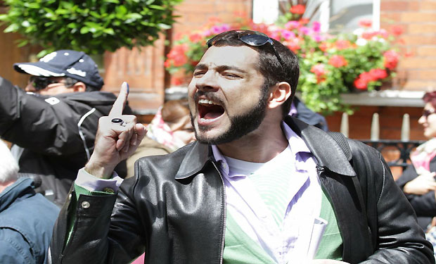 Iranian voter gestures outside Iran consulate in London after voting. (AAA/James Hanna)