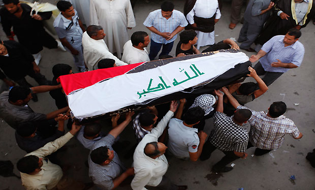 Relatives carry the coffin of an Iraqi soldier killed by militants during a funeral in Najaf, 160 km (100 miles) south of Baghdad, April 28, 2013. (Reuters/Haider Ala)