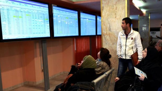 FILE - In this file photo taken in Feb. 3, 2013 - Iraqi stock traders watch the sales screen at the Iraq Stock Exchange in Baghdad, Iraq. Citigroup Inc. is set to become the first American bank to open an office under its own name in Baghdad, highlighting international financial firms' growing interest in Iraq a decade after the U.S.-led invasion. (AP Photo/ Hadi Mizban, File)