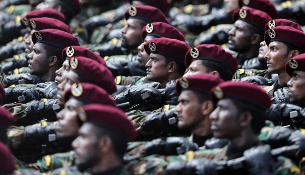 Sri Lankan government soldiers march in a war victory parade in Colombo, Sri Lanka, Saturday, May 18, 2013. (AP/Eranga Jayawardena)