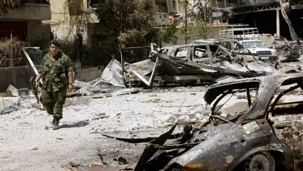 A Lebanese soldier inspects the area outside the Bilal bin Rabah mosque, scene of this week's deadly clashes between the Lebanese army and supporters of radical Sunni cleric Sheikh Ahmad al-Assir, in the Abra district of the southern city of Sidon on June 28, 2013. AFP PHOTO/MAHMOUD ZAYYAT