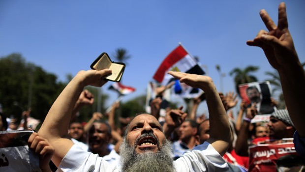 Supporters of ousted Egyptian President Mohammed Morsi chant slogans during a protest near the University of Cairo, Giza, Egypt, Friday, July 5, 2013. (AP Photo/Hassan Ammar)