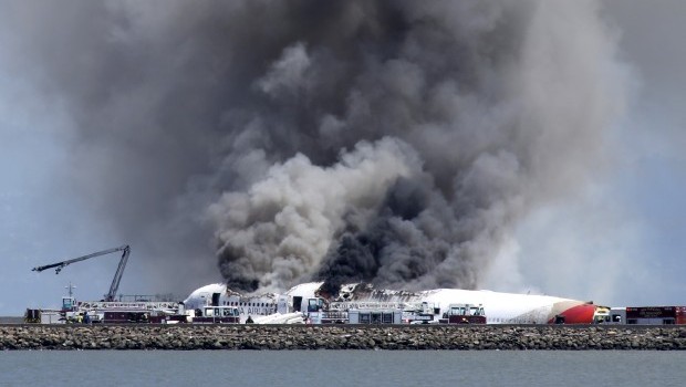 Fire crews work the crash site of Asiana Flight 214 at San Francisco International Airport in San Francisco, Saturday, July 6, 2013. (AP Photo/Bay Area News Group, John Green)