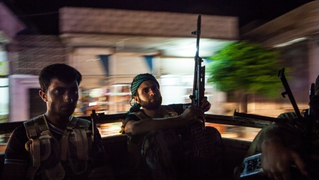 Syrian rebels head to the town of Bsankol in the northwestern province of Idlib to join comrades fighting regime forces for the control of the highway that connects Idlib with Latakia on July 11, 2013. (AFP PHOTO/DANIEL LEAL-OLIVAS.)