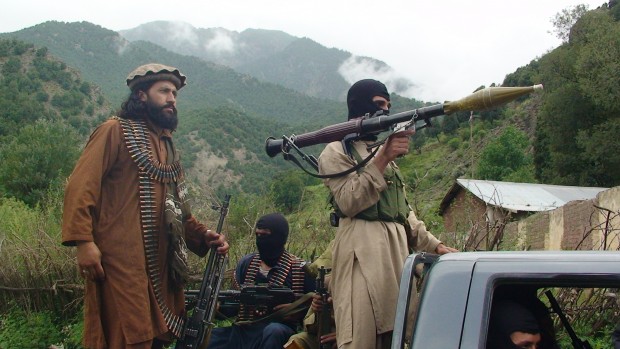 In this file photo taken on Sunday, Aug. 5, 2012, Pakistani Taliban patrol in their stronghold of Shawal in Pakistani tribal region of South Waziristan. Dozens of domestic and foreign militants have left Pakistan for Syria in recent months, a small but growing cadre that includes fighters from al-Qaida, the Pakistani Taliban and Sulemans group, Lashkar-e-Jhangvi, according to Pakistani militants and intelligence officials. (AP Photo/Ishtiaq Mahsud, File)