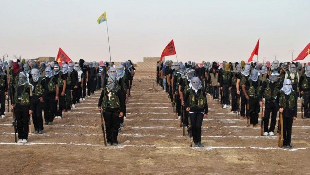 Kurdish opposition fighters attend a ceremony on July 18, 2013, in the northern Syrian border village of al Qamishli. At least 29 people have been killed in fighting between Kurdish and jihadist fighters in northern Syria in the past two days, the Syrian Observatory for Human Rights said (AFP PHOTO/STR)