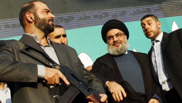 Lebanon's Hezbollah leader Sayyed Hassan Nasrallah (2nd R), escorted by his bodyguards, greets his supporters at an anti-U.S. protest in Beirut's southern suburbs, in this September 17, 2012 file photo (REUTERS/Sharif Karim/Files)