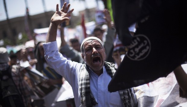 A supporter of Egypt's ousted President Mohammed Morsi chants slogans against the army during a protest Cairo University, in Giza, Egypt, Friday, July 26, 2013. (AP Photo/Manu Brabo)