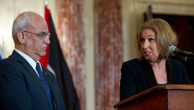 Israel's chief negotiator and Justice Minister Tzipi Livni (R) turns to chief Palestinian negotiator Saeb Erakat (L) as she speaks to the press with US Secretary of State John Kerry at the State Department in Washington,DC on July 30, 2013.