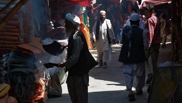 An Afghan trader fans herbs called spand at a market in Kabul on July 15, 2013. Source: AFP Photo/Massoud Hossaini
