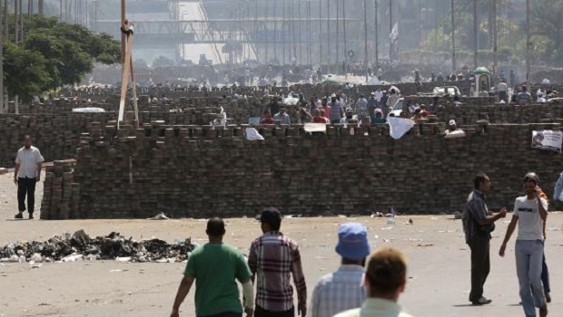 Supporters of ousted president Mohamed Morsi walk near road blocks following clashes with police forces, near the tomb of former President Anwar al-Sadat, in Cairo, Egypt, 27 July 2013. EPA/MOHAMMED SABER