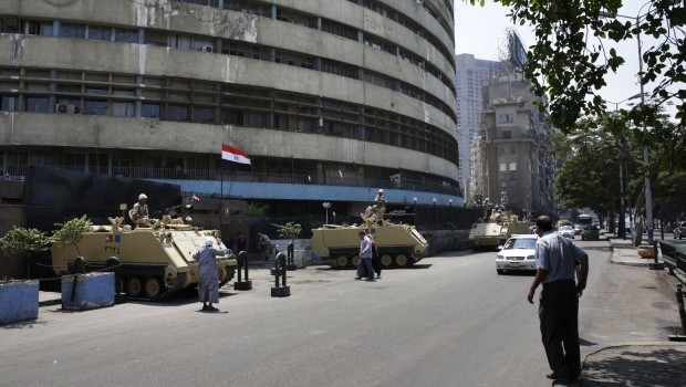 Egyptian military soldiers stand guard atop armored personnel carriers at Maspero, an Egypt's state tv and radio station, not far from Tahrir Square in Cairo Saturday, July 6, 2013. Source: AP Photo/Hiro Komae