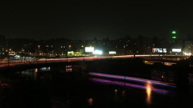The Agouza neighborhood, background, is seen during a power cut, in Giza, Egypt, Sunday, June 2, 2013. (AP Photo/Hassan Ammar)