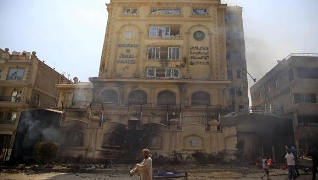 Egyptian protesters attack the Muslim Brotherhood headquarters in the Muqattam district in Cairo, Monday, July 1, 2013. (AP Photo/Khalil Hamra)