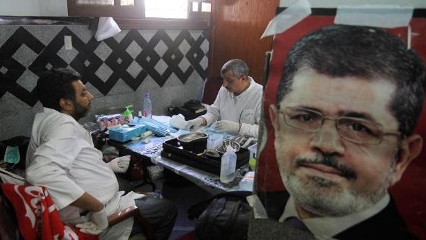 Medics sit in a makeshift hospital after Egyptian soldiers and police opened fire on supporters of the ousted President Mohamed Mursi, early Monday in Cairo, Egypt on Monday, July 8, 2013. (AP Photo/ Ahmed Gomaa)