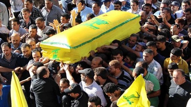 Mourners carry the coffin of a Lebanese Hezbollah fighter, draped in the flag of the Lebanese Shiite Muslim party, who was killed in Syria during his funeral procession on July 5, 2013. AFP PHOTO /ALI DIA