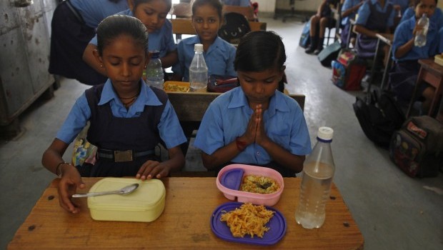A schoolgirl prays before having her free mid-day meal, distributed by a government-run primary school, in New Delhi July 5, 2013. Soure: Reuters/Mansi Thapliyal