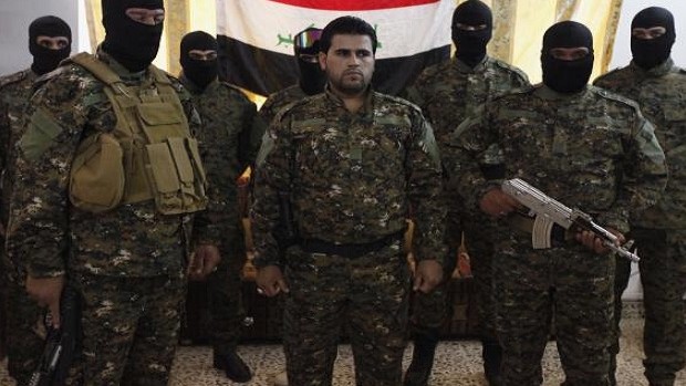 Fighters from Iraq's Islamist Shi'ite militias pose for pictures before departing to Syria from Baghdad, June 11, 2013. REUTERS/Thaier al-Sudani 