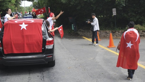 Protesters chant as they pass by the entrance to the the Golden Generation Worship & Retreat Center in Saylorsburg, Pa. on Saturday, July 13, 2013 to demonstrate against Turkish cleric Fethullah Gulen, who rents a room at the center. Source: AP Photo/Pocono Record/Keith R. Stevenson