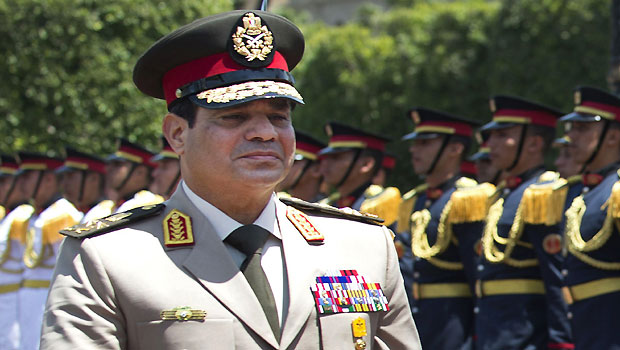 In this Wednesday, April 24, 2013 file photo, Egyptian Defense Minister Gen. Abdel-Fattah el-Sissi reviews honor guards during an arrival ceremony for his U.S. counterpart at the Ministry of Defense in Cairo. (AP/Jim Watson, Pool)