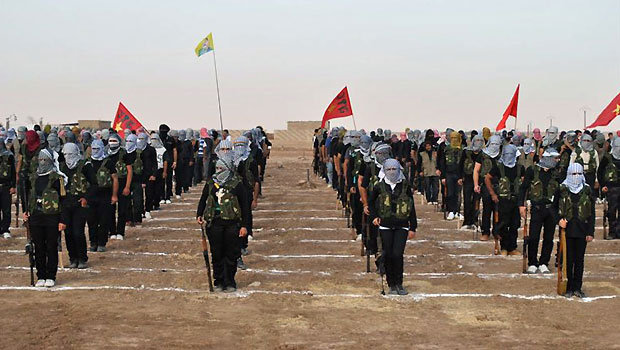 Kurdish opposition fighters attend a ceremony on July 18, 2013, in the northern Syrian border village of al Qamishli. (AFP)