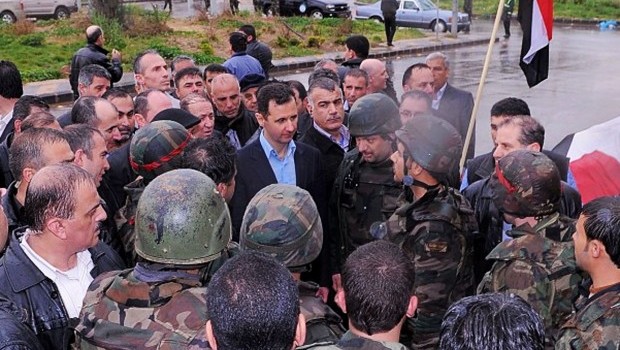 This undated photo posted on the official Instagram account of the Syrian Presidency purports to show Bashar Assad visiting with soldiers in Baba Armr, Homs province, Syria, in 2012 (AP Photo/Syrian Presidency via Instagram)
