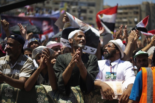 Members of the Muslim brotherhood and supporters of ousted Egyptian President Mohammed Morsi attend a sit-in outside the Rabaa al-Adawiya mosque on the first day of Eid al-Fitr celebrations on August 8, 2013 in Cairo. (AFP PHOTO/GIANLUIGI GUERCIA)