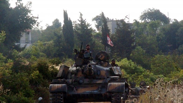 A handout picture released by the Syrian Arab News Agency (SANA) on August 8, 2013 shows Syrian army tanks parked on the side of a road during an alleged pursuit of opposition fighters in the Latakia province, western Syria. (AFP PHOTO/HO/SANA.)