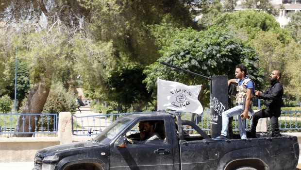 Free Syrian Army fighters stand on a back of a truck mounted with an anti-aircraft gun in Raqqa province, eastern Syria August 12, 2013. (REUTERS/Nour Fourat.)